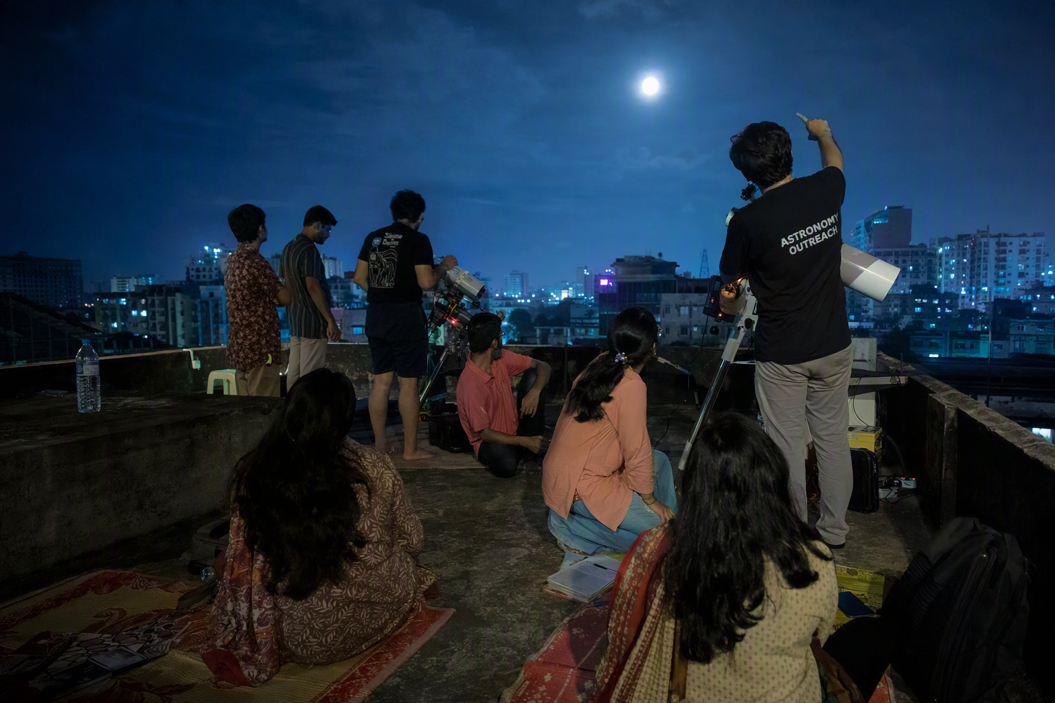 An astronomer pointing toward constellations with a cyan laser while visitors sit beneath the open night sky