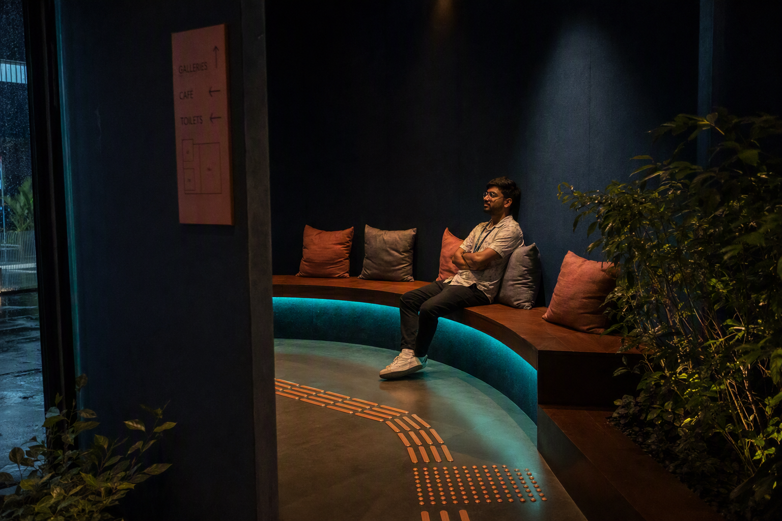 A calm blue quiet room with individual seats, dimmable lamps, and acoustic wall panels